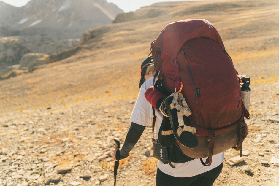 Backpacker with gear on Teton Crest Trail in Wyoming's wilderness.