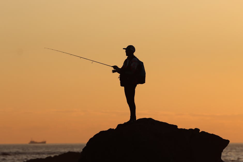 A serene silhouette of a fisherman casting a line against a vibrant sunset at Matosinhos Beach in Portugal.