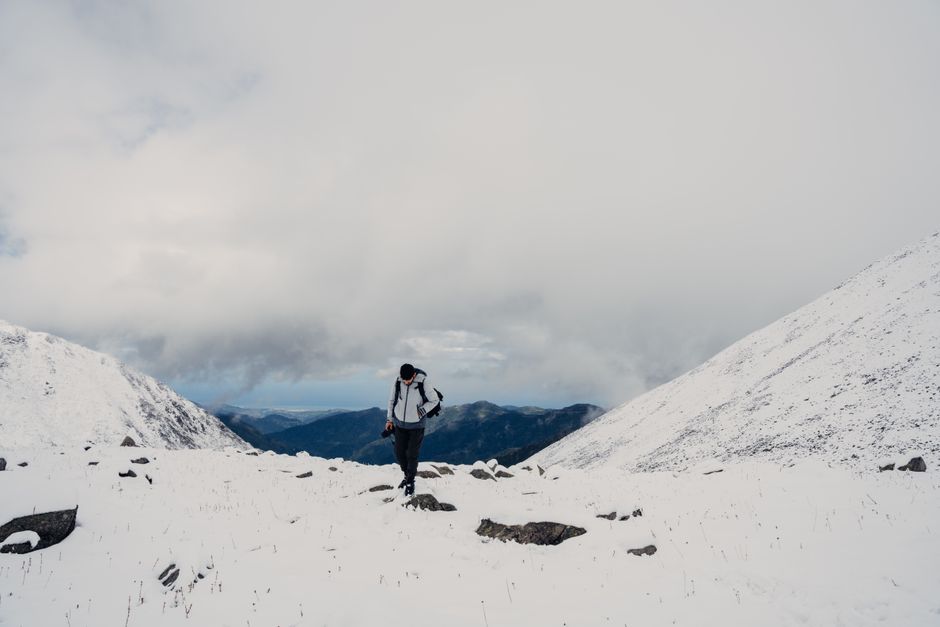 Hiker explores snowy mountain, capturing the essence of winter adventure.